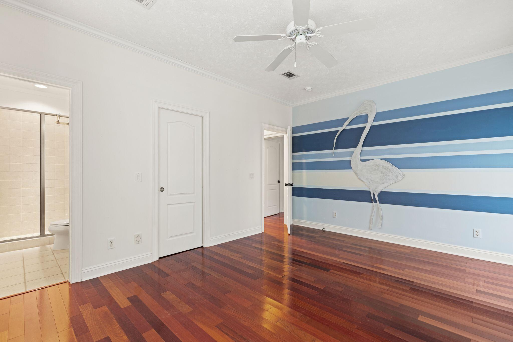 31 Seabreeze Place Inlet Beach, FL 32461 - Photo 40 of 67 a view of an empty room with wooden floor and a ceiling fan