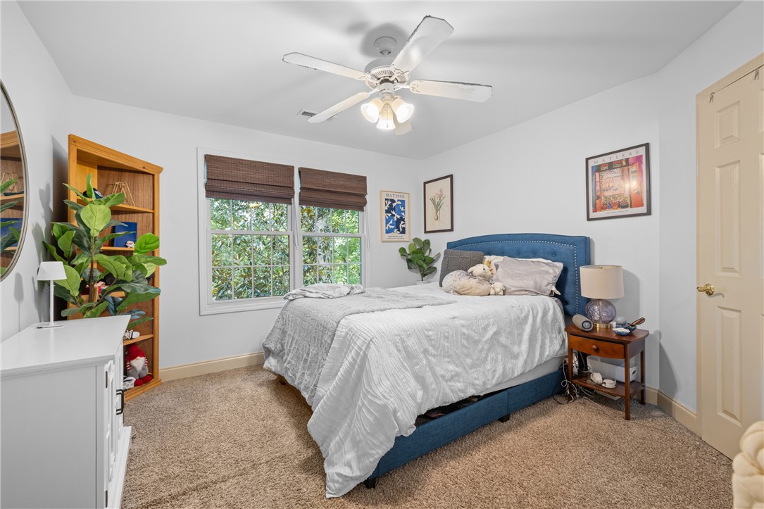 106 Red Maple Way Clemson, SC 29631 - Photo 25 of 49 Plush carpeting and wide windows framing leafy views define this serene sleeping space.