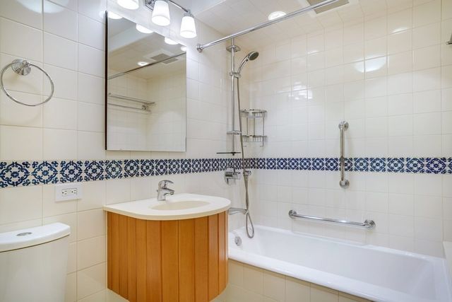 a bathroom with a sink a toilet and a mirror