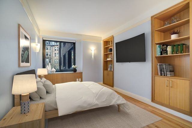 a bedroom with a bed and a television