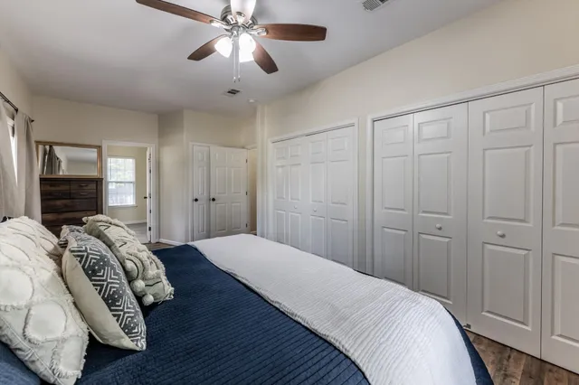 a bedroom with a bed and a chandelier