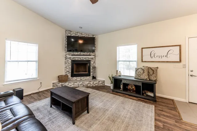 a living room with furniture and a fireplace