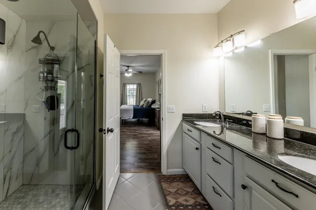 a spacious bathroom with a shower sink and mirror