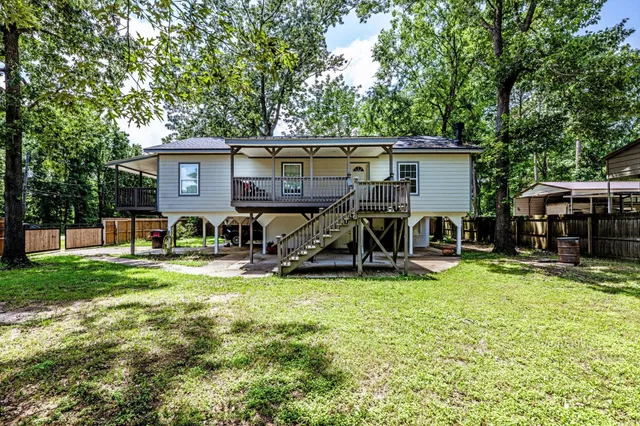 a view of a house with backyard sitting area and garden