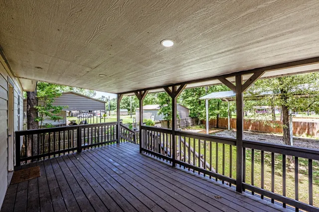 a view of a balcony with wooden floor