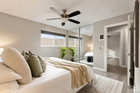 a bedroom with a bed and a chandelier