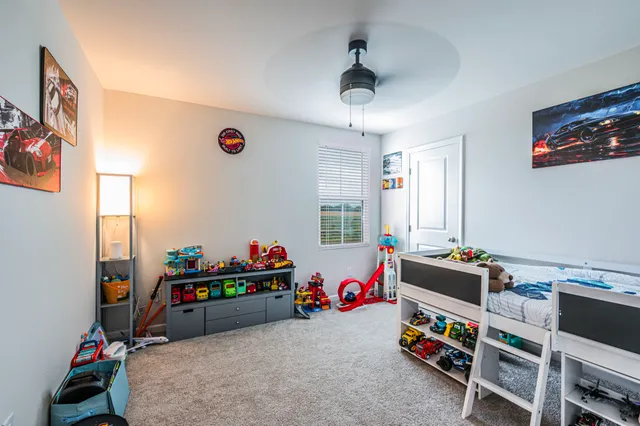 a kids room with toys and a flat screen tv