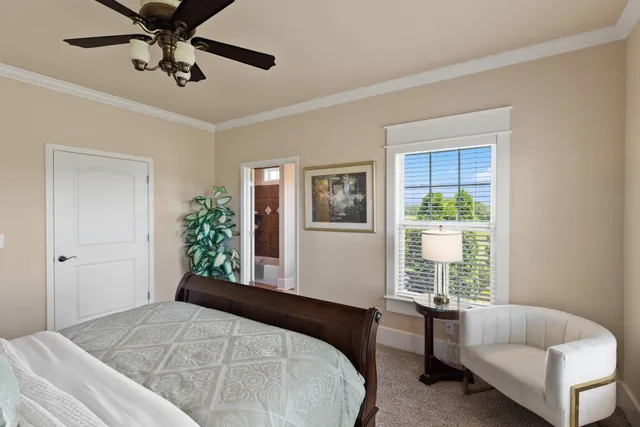 a living room with furniture pool table and windows