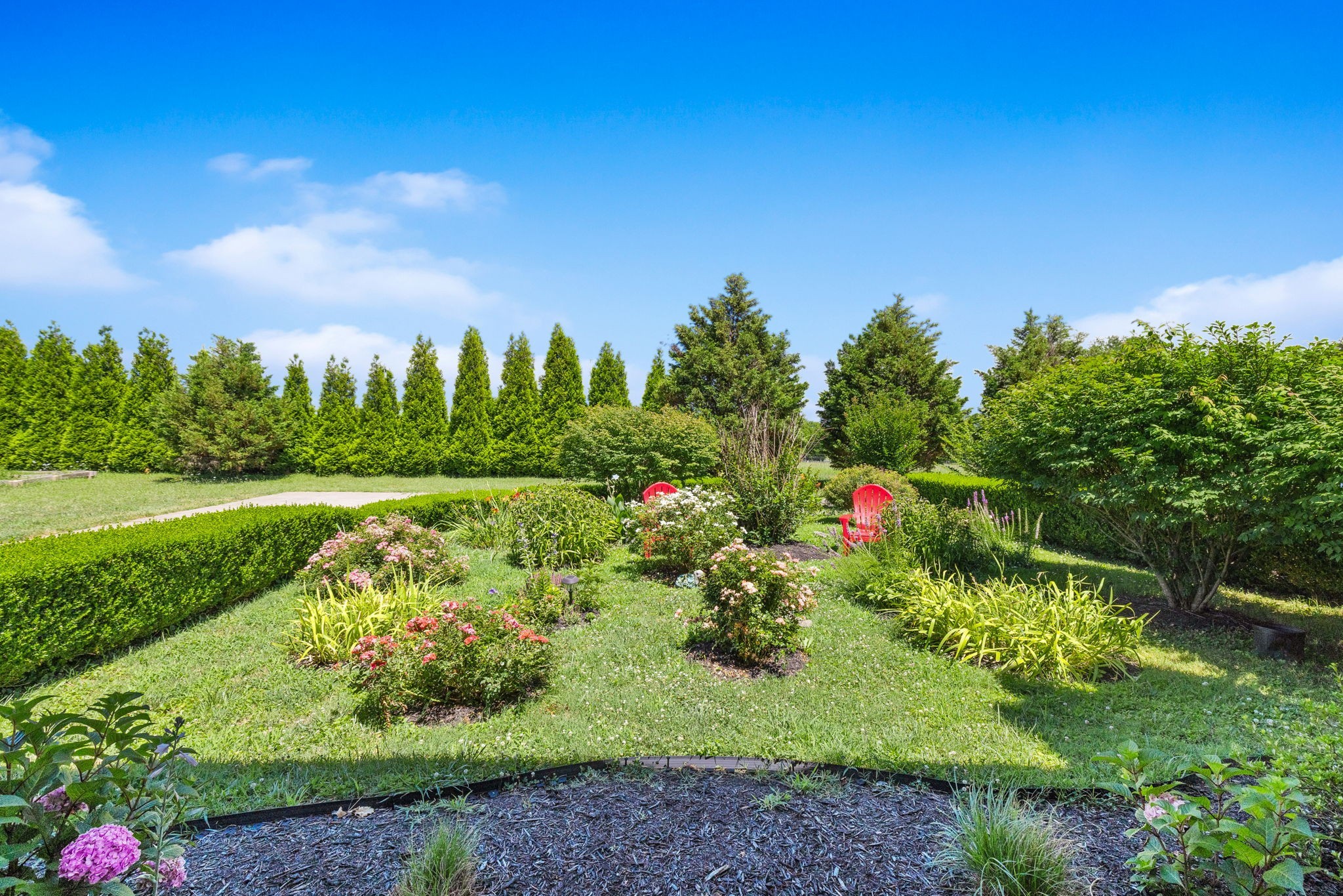8288 Guthrie Road Cross Plains, TN 37049 - Photo 79 of 94 a view of a garden with a building in the background