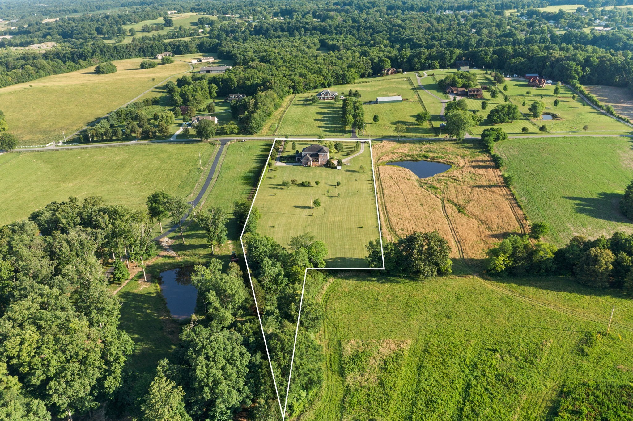 8288 Guthrie Road Cross Plains, TN 37049 - Photo 81 of 94 an aerial view of a house with a garden and lake view