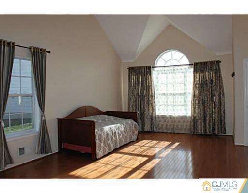 78 Springfield Road North Brunswick, NJ 08902 - Photo 2 of 19 a bedroom with a bed and a large window