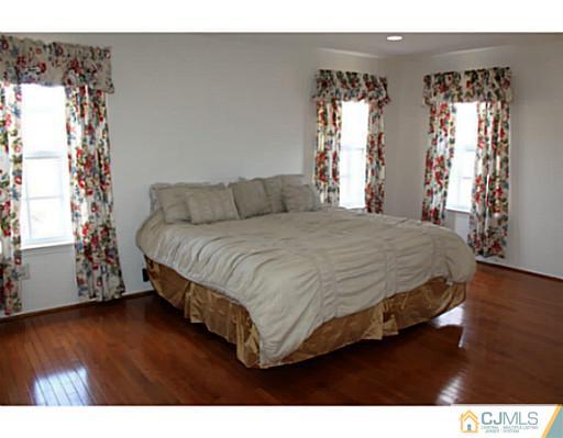 78 Springfield Road North Brunswick, NJ 08902 - Photo 11 of 19 a bedroom with a bed mirror and window
