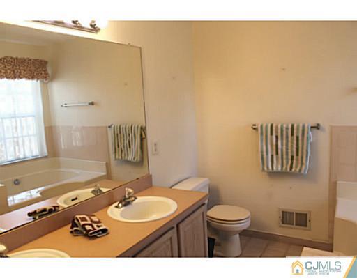 78 Springfield Road North Brunswick, NJ 08902 - Photo 12 of 19 a bathroom with a toilet sink and mirror