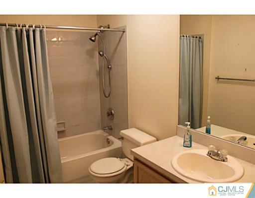 78 Springfield Road North Brunswick, NJ 08902 - Photo 15 of 19 a bathroom with a sink toilet a shower and a mirror