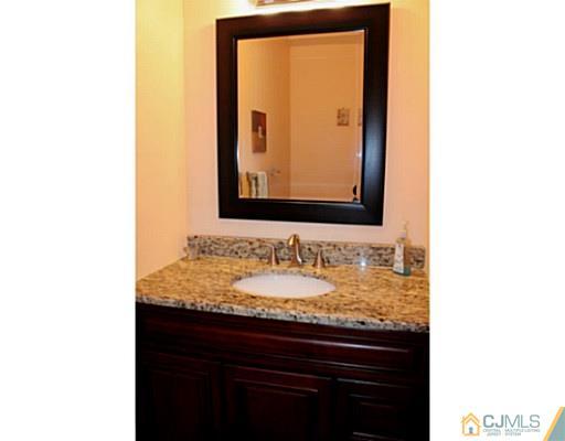 78 Springfield Road North Brunswick, NJ 08902 - Photo 9 of 19 a bathroom with a sink and a mirror