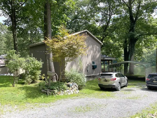 a car parked in front of a house and cars parked