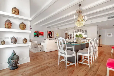 a dining room with furniture a chandelier and wooden floor