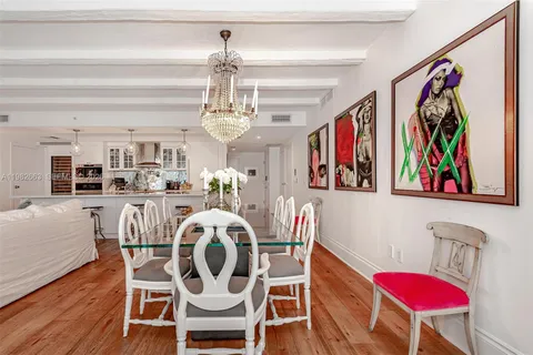 a view of a dining room with furniture wooden floor and a chandelier
