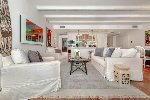 a living room with furniture and a painting on the wall