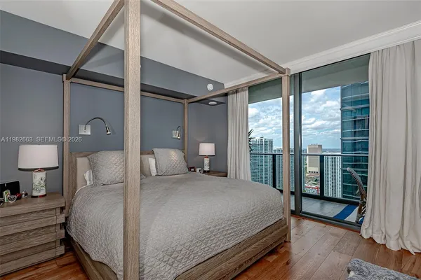 a bedroom with a large bed and a large window