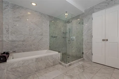 a bathroom with a bathtub and a shower