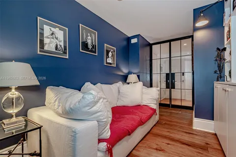 a bedroom with a bed and wooden floor