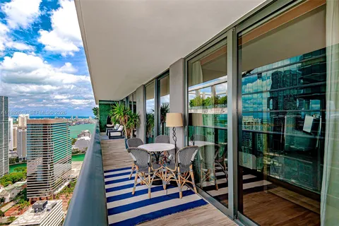 a view of a chairs and table in a balcony