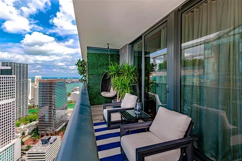 a view of balcony with chairs and potted plants
