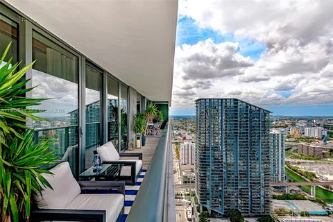 a view of balcony with wooden floor and outdoor seating