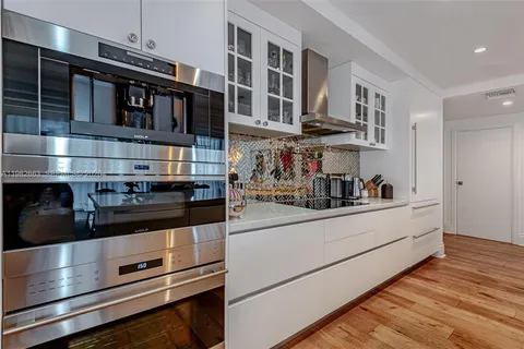 a kitchen with stainless steel appliances granite countertop a stove and cabinets