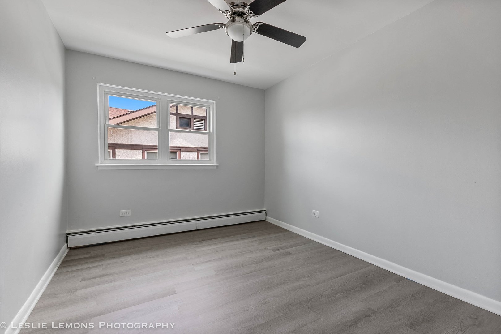 912 State Street, Unit 2 Lemont, IL 60439 - Photo 11 of 25 an empty room with chandelier fan and windows