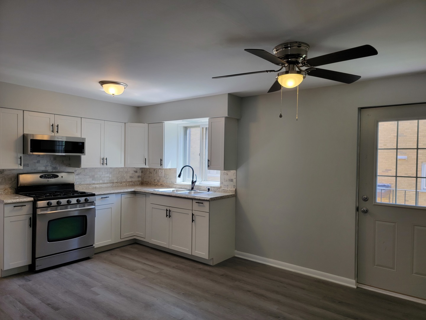 912 State Street, Unit 2 Lemont, IL 60439 - Photo 16 of 25 a kitchen with a sink stainless steel appliances and cabinets