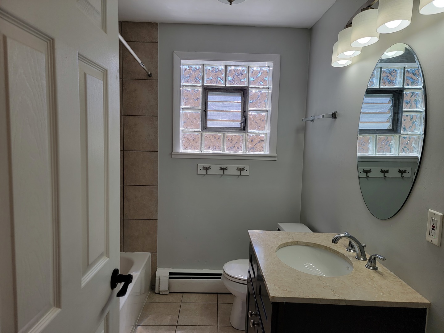 912 State Street, Unit 2 Lemont, IL 60439 - Photo 18 of 25 a bathroom with a sink a toilet and mirror
