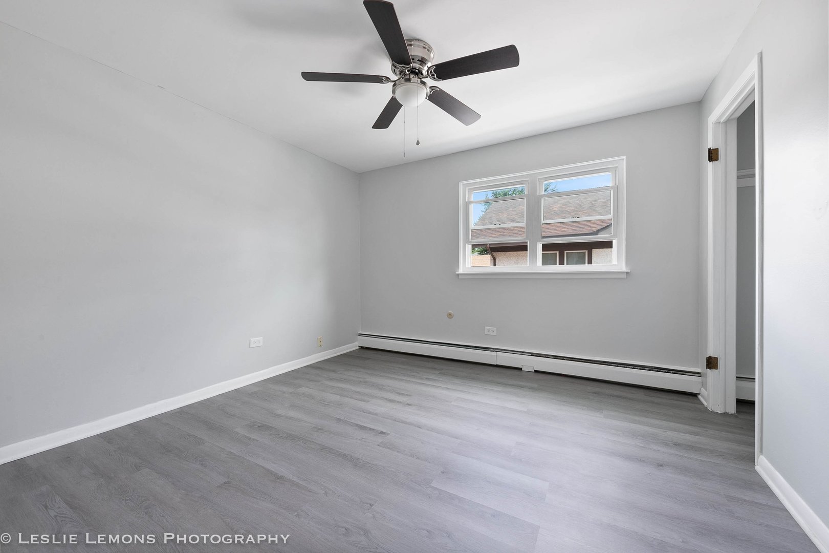 912 State Street, Unit 2 Lemont, IL 60439 - Photo 7 of 25 wooden floor in an empty room with a window