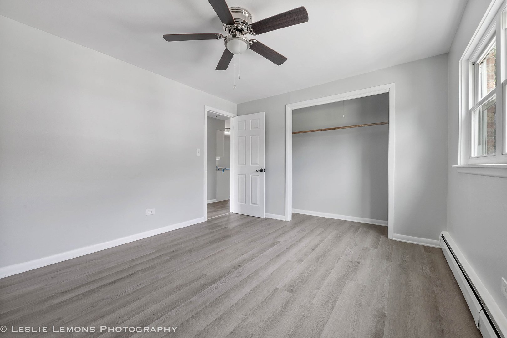 912 State Street, Unit 2 Lemont, IL 60439 - Photo 10 of 25 an empty room with wooden floor a ceiling fan and closet