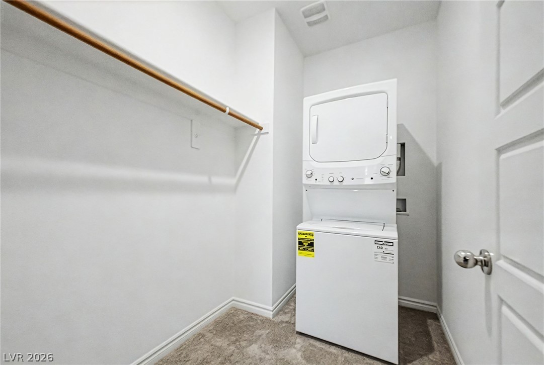 226 Augusta Ridge Henderson, NV 89015 - Photo 27 of 47 This dedicated laundry space features convenient stacked appliances and essential hanging storage.
