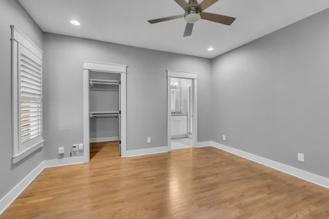 a kitchen with kitchen island granite countertop stainless steel appliances a refrigerator microwave a sink a stove a counter space and cabinets