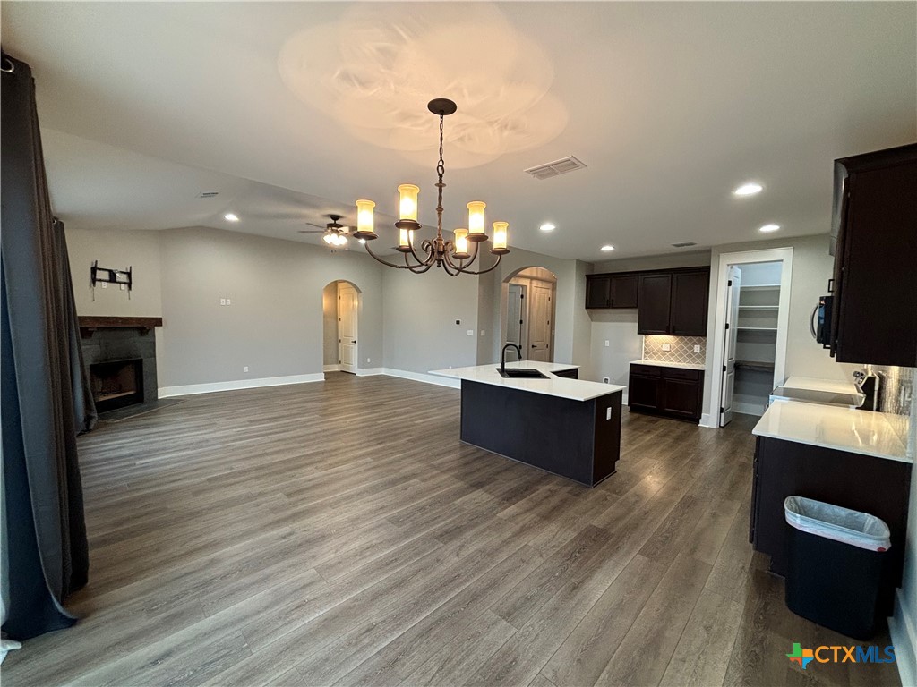 110 Hiram Cook Blanco, TX 78606 - Photo 30 of 46 a large living room with kitchen island furniture and a wooden floor