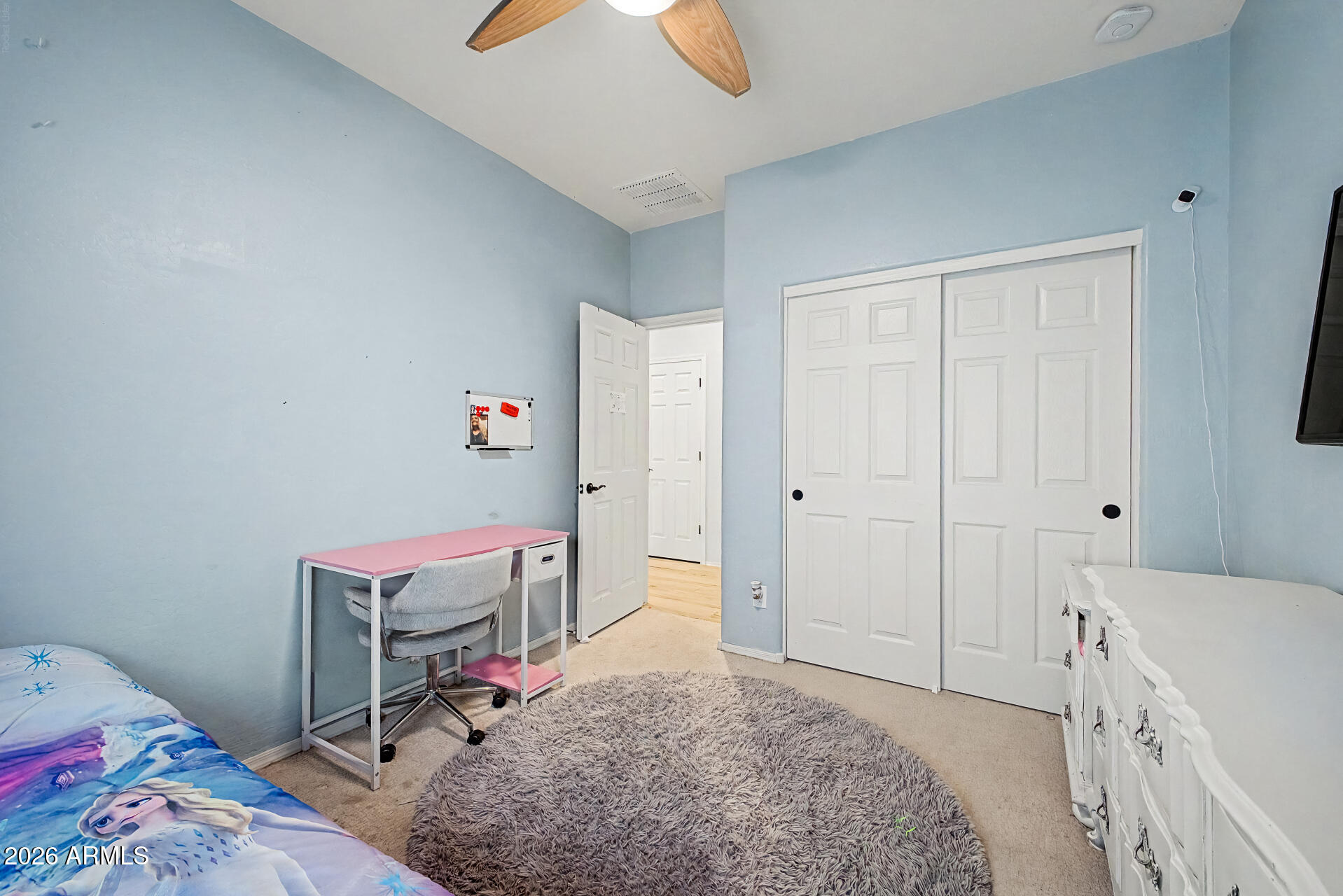 16719 West Rowel Road Surprise, AZ 85387 - Photo 17 of 28 a bedroom with a bed and a cabinets