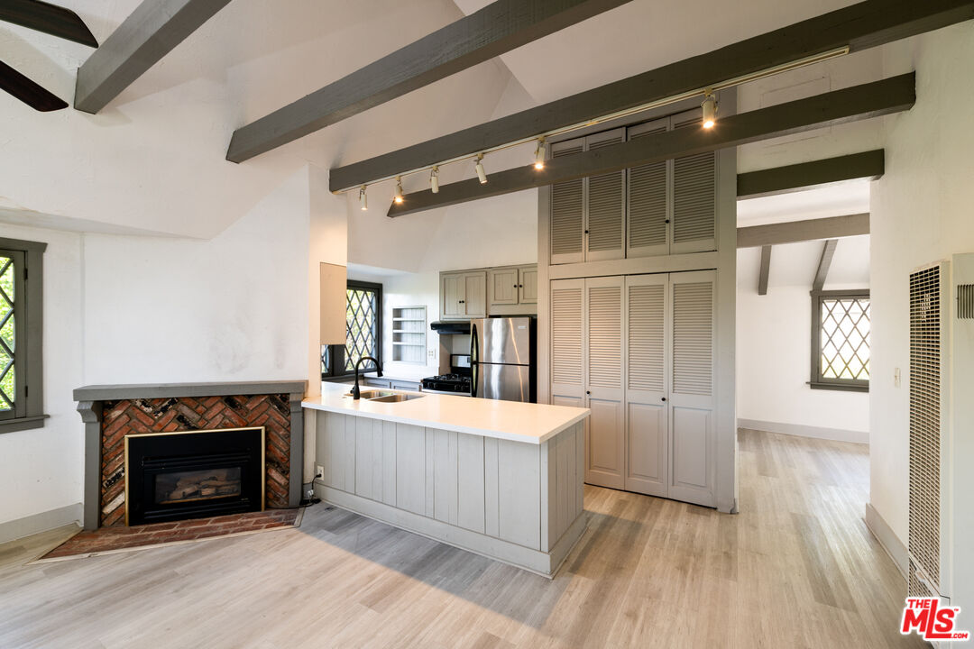 1954 Hillcrest Road, Unit 3 Los Angeles, CA 90068 - Photo 14 of 26 a large kitchen with cabinets and wooden floor