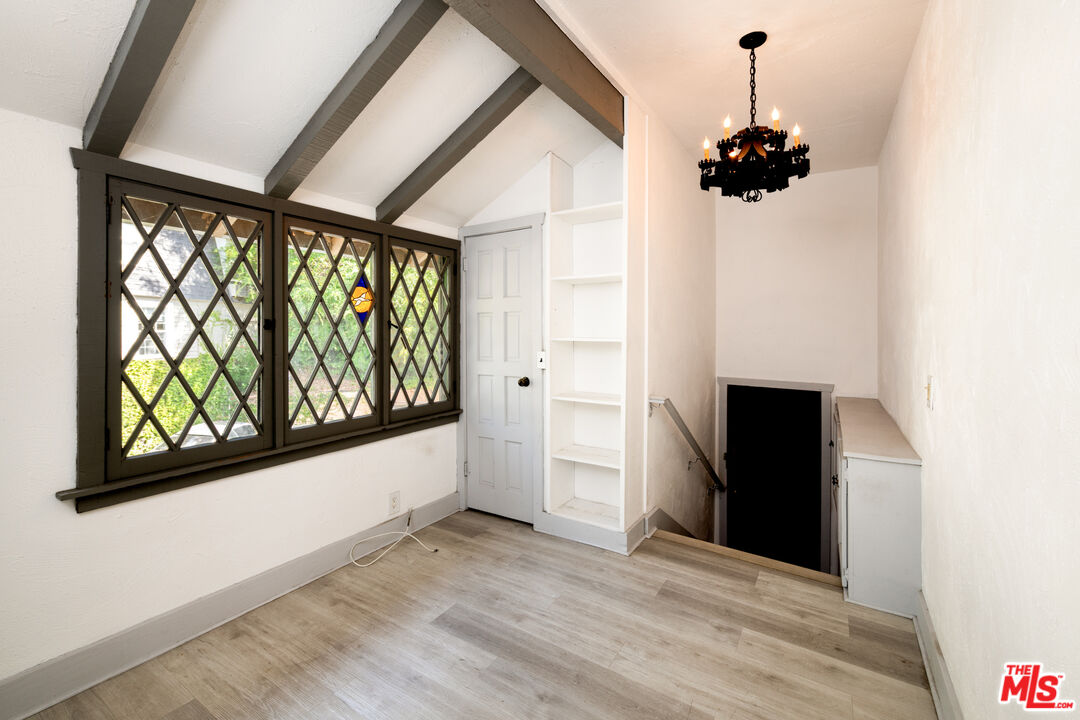 1954 Hillcrest Road, Unit 3 Los Angeles, CA 90068 - Photo 4 of 26 a view of a room with a window and wooden floor
