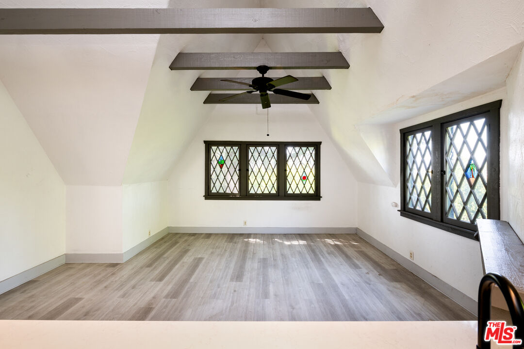 1954 Hillcrest Road, Unit 3 Los Angeles, CA 90068 - Photo 7 of 26 a view of an empty room with a window and wooden floor