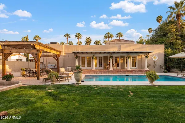 a view of a green field with building in the background