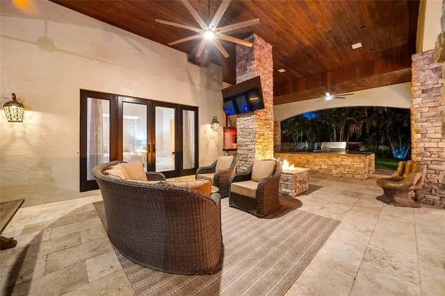 a living room with furniture a flat screen tv and a fireplace