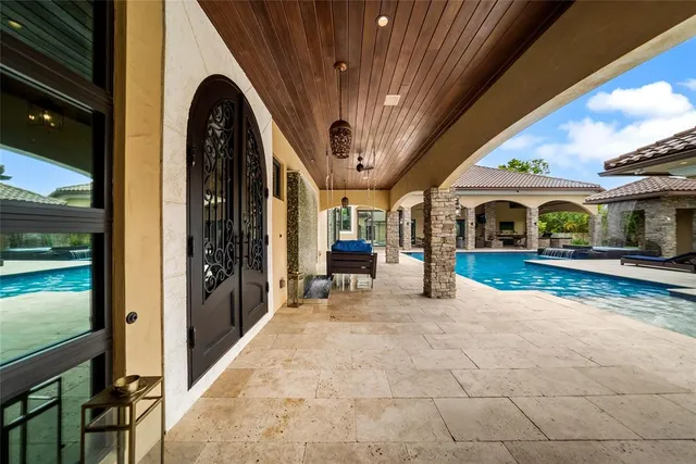 an aerial view of a house with a yard and lake view