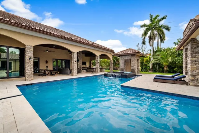 a swimming pool with outdoor seating