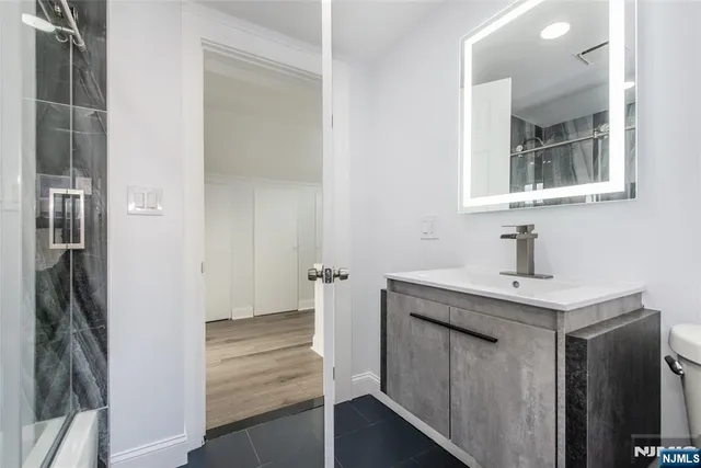 a bathroom with a sink and mirror