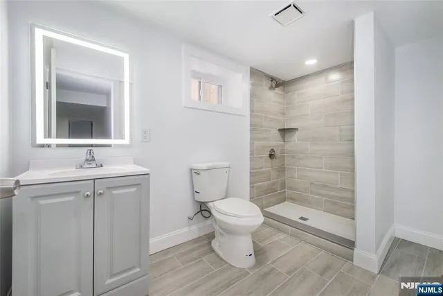 a bathroom with a toilet sink and shower