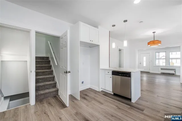 a view of a kitchen with wooden floor and a kitchen