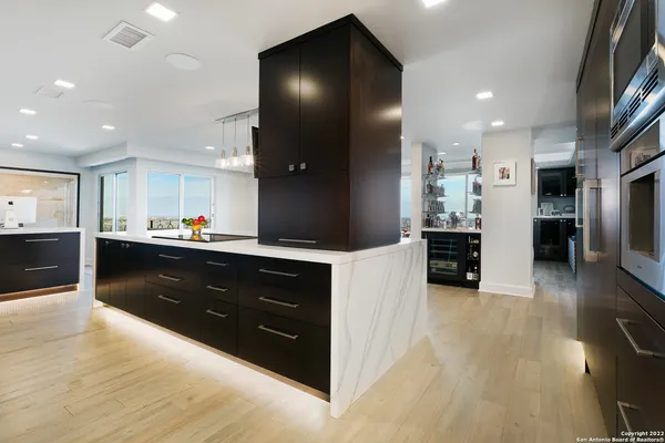 a kitchen with stainless steel appliances granite countertop a refrigerator and a sink